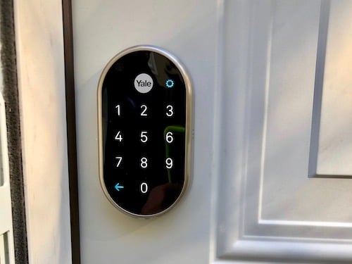 Yale smart nest lock installed on white metal door