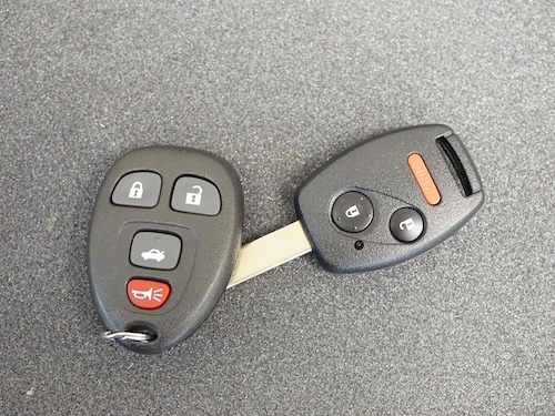 car key and car remote on grey table