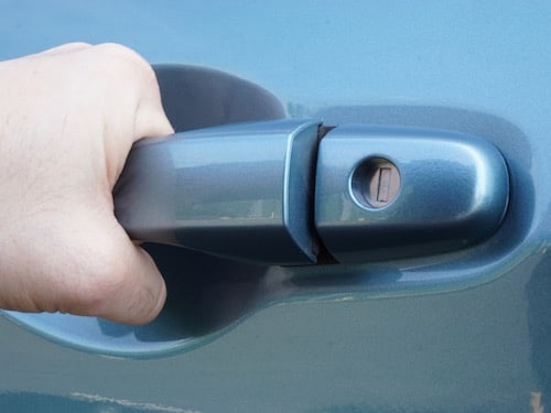 hand pulling on car door handle